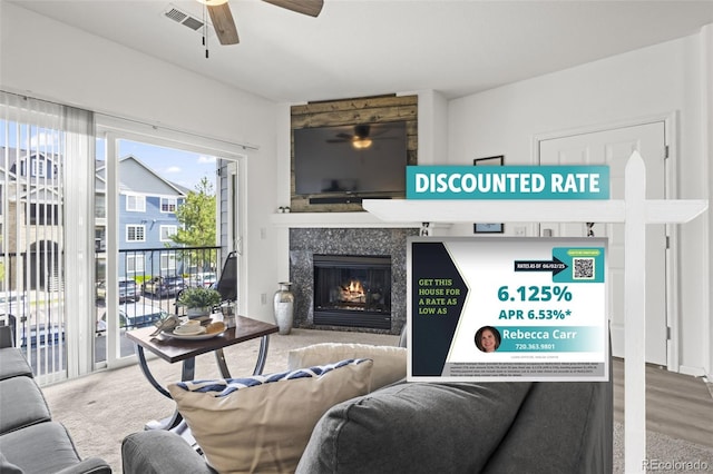 4451 S Ammons St Unit 4-203, Littleton, CO 80123 - living room featuring ceiling fan and a high end fireplace