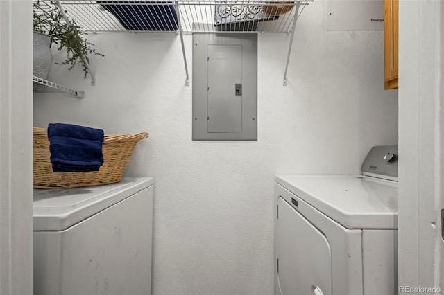 4451 S Ammons St Unit 4-203, Littleton, CO 80123 - washroom featuring electric panel, washing machine and dryer, and cabinet space