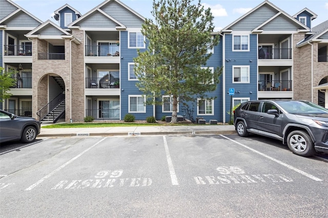4451 S Ammons St Unit 4-203, Littleton, CO 80123 - view of apartment building / complex with uncovered parking