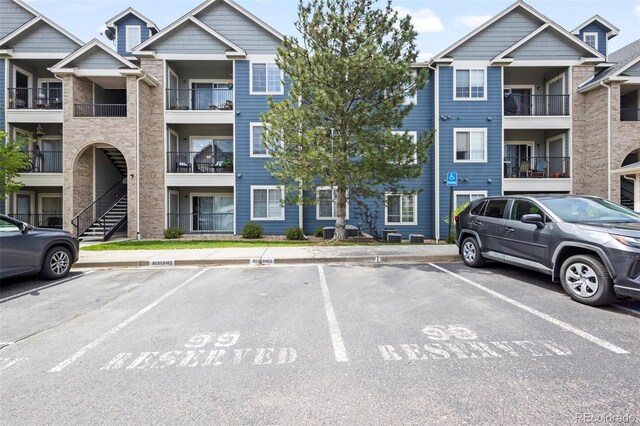 4451 S Ammons St Unit 4-203, Littleton, CO 80123 - view of apartment building / complex with uncovered parking