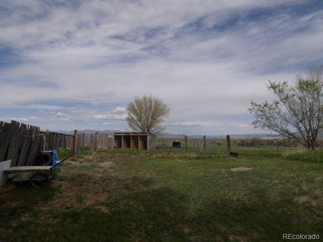 view of yard with a rural view