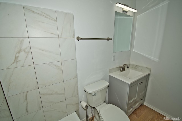 bathroom with vanity, hardwood / wood-style flooring, and toilet