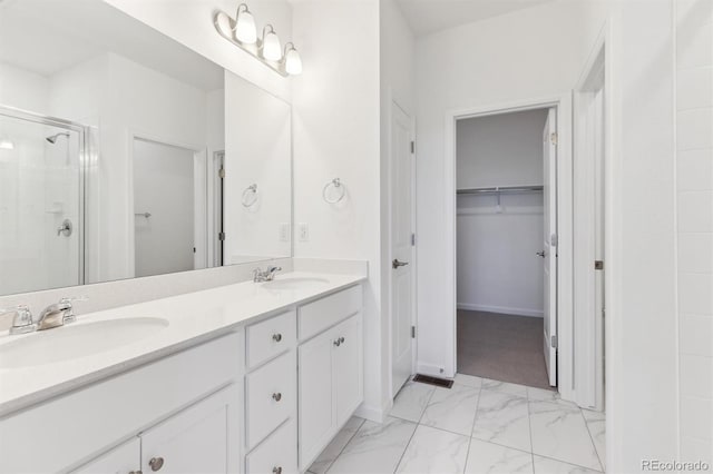 bathroom with vanity and a shower with shower door