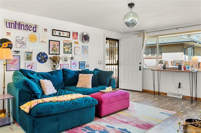 living room with baseboards and wood finished floors