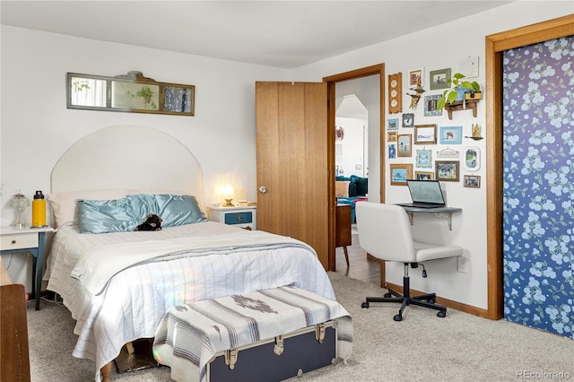 bedroom featuring carpet floors and baseboards