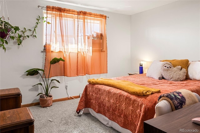 carpeted bedroom featuring baseboards
