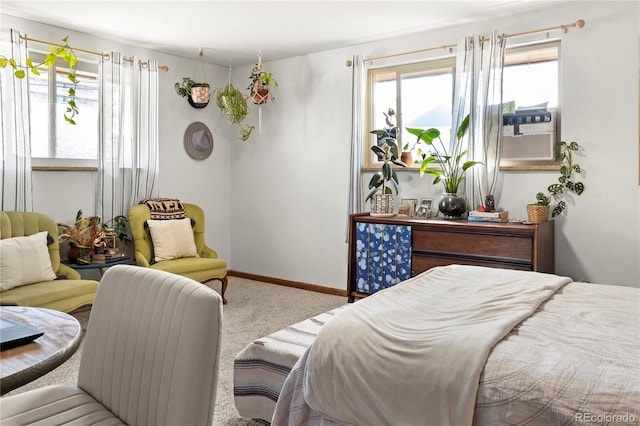 carpeted bedroom with cooling unit, baseboards, and multiple windows
