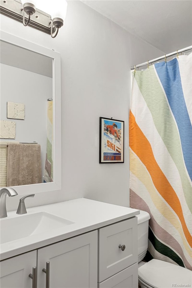 bathroom featuring vanity and toilet