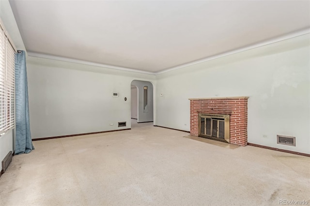 10841 Montview Blvd, Aurora, CO 80010 - unfurnished living room with carpet floors, a fireplace, and arched walkways