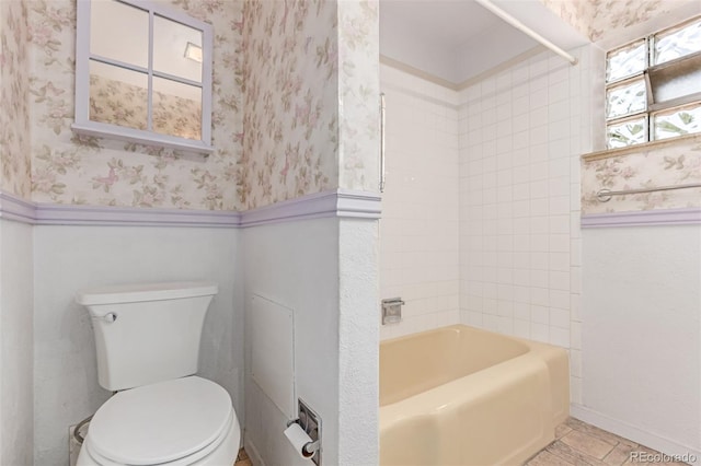 10841 Montview Blvd, Aurora, CO 80010 - bathroom featuring wallpapered walls, bathing tub / shower combination, and wainscoting