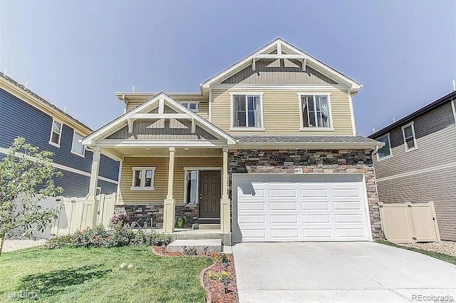 craftsman house featuring a garage, a front lawn, and covered porch