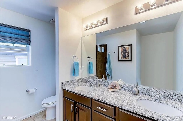 bathroom with tile patterned floors, vanity, and toilet