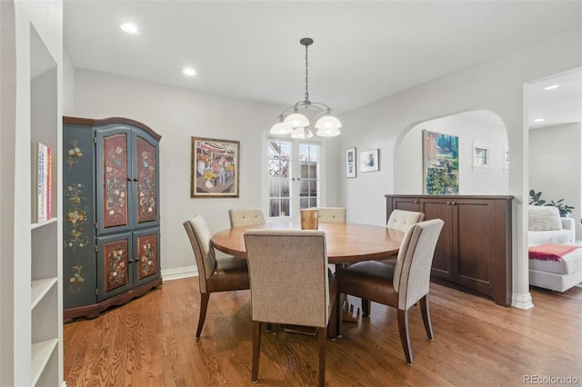 dining room featuring recessed lighting, baseboards, a notable chandelier, and wood finished floors
