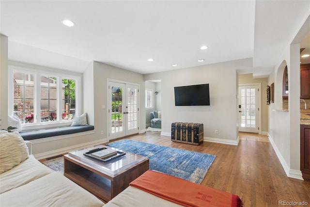 living room with recessed lighting, baseboards, visible vents, and wood finished floors