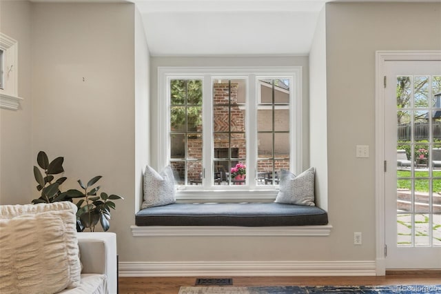 interior space featuring baseboards, visible vents, and wood finished floors