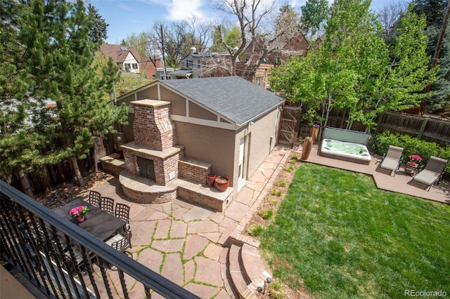 exterior space with a fenced backyard, an outdoor brick fireplace, and a patio area