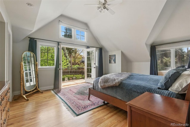 bedroom featuring baseboards, vaulted ceiling, light wood-type flooring, and access to exterior