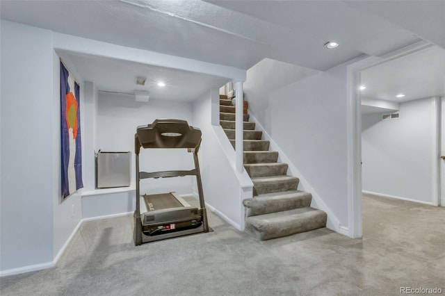 exercise room with carpet floors, baseboards, recessed lighting, and visible vents