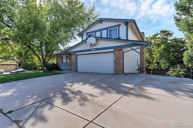 11008 Vrain Ct, Westminster, CO 80031 - tudor home with driveway, brick siding, and a garage