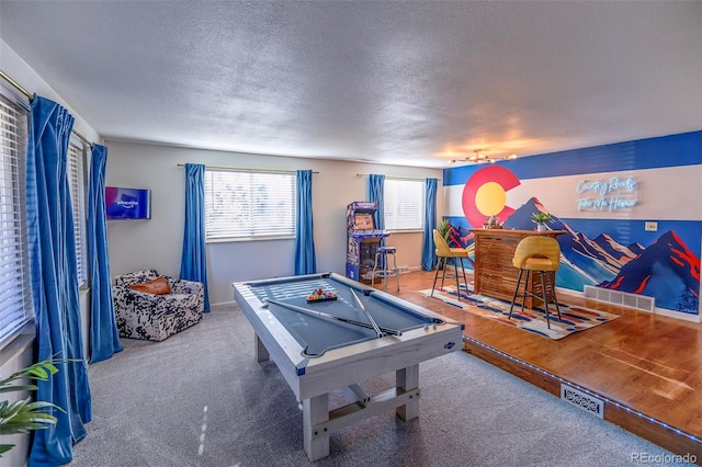 game room with carpet floors, a textured ceiling, billiards, and bar