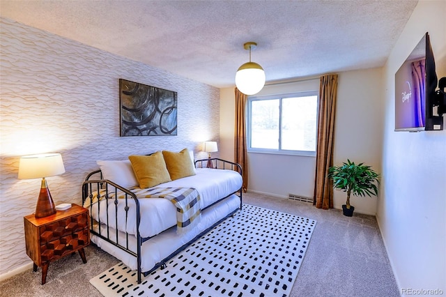 bedroom with a textured ceiling and carpet flooring