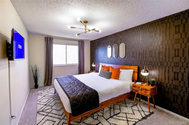 bedroom featuring a chandelier, a textured ceiling, and light colored carpet