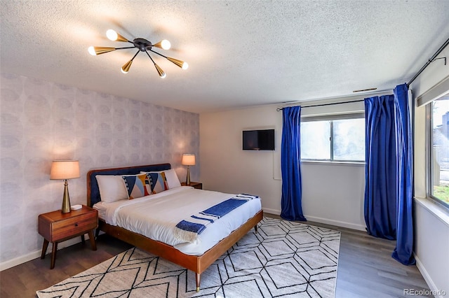 bedroom with a textured ceiling and hardwood / wood-style floors