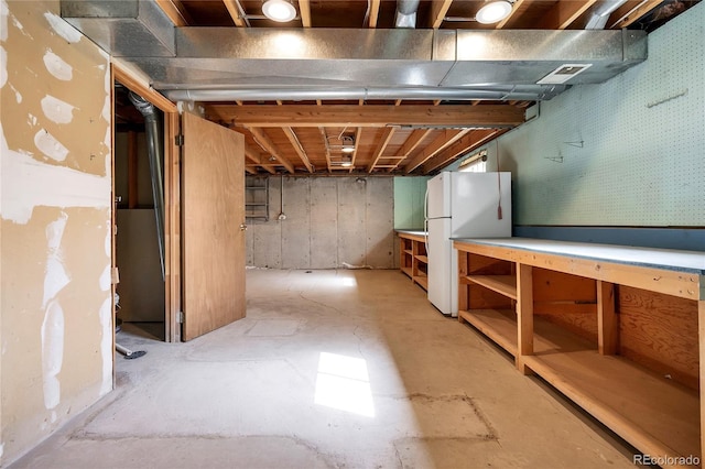 basement featuring white refrigerator