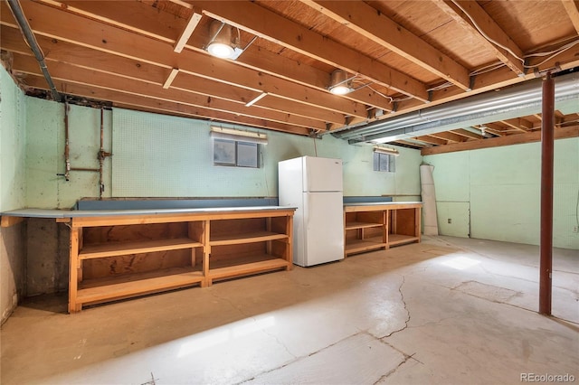 11008 Vrain Ct, Westminster, CO 80031 - basement featuring freestanding refrigerator and a workshop area
