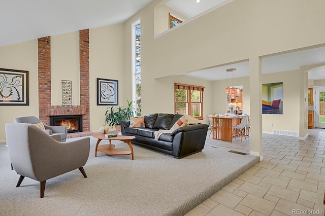 7882 S Valentia Way, Centennial, CO 80112 - living room with a high ceiling, a brick fireplace, and baseboards
