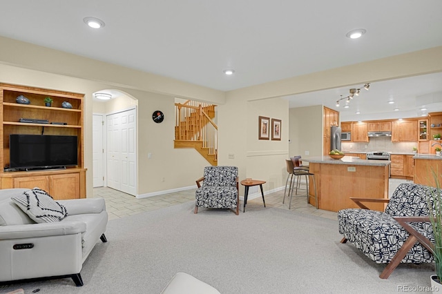 7882 S Valentia Way, Centennial, CO 80112 - living room featuring stairs, baseboards, light tile patterned floors, recessed lighting, and light carpet