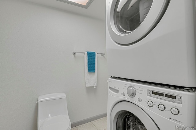 7882 S Valentia Way, Centennial, CO 80112 - laundry room with estacked washer and dryer, light tile patterned floors, and baseboards