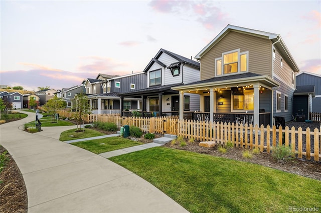 view of front of house with covered porch and a yard