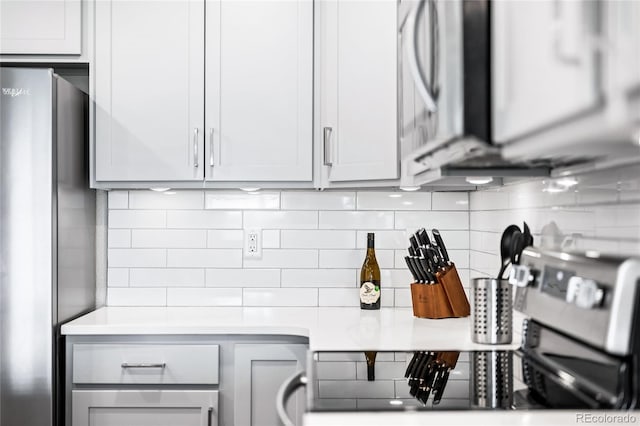 kitchen featuring stainless steel fridge and backsplash