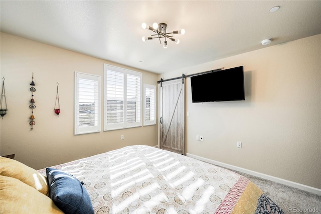 carpeted bedroom featuring a barn door and a chandelier