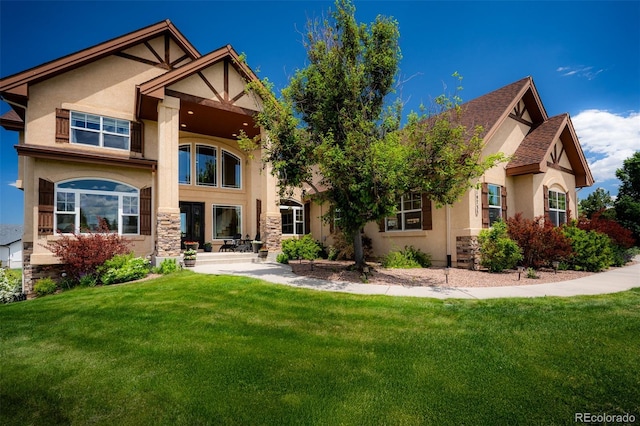 19735 Knights Xing, Monument, CO 80132 - back of property featuring stucco siding, a lawn, and stone siding