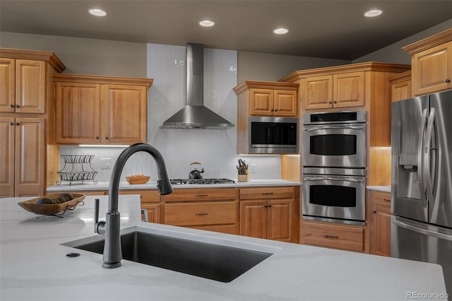 19735 Knights Xing, Monument, CO 80132 - kitchen featuring stainless steel appliances, wall chimney exhaust hood, tasteful backsplash, and recessed lighting