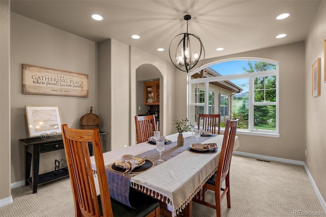 19735 Knights Xing, Monument, CO 80132 - dining space with light carpet, a chandelier, arched walkways, and recessed lighting