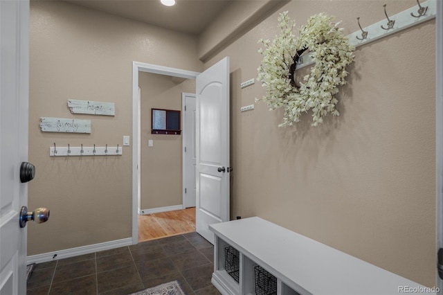 19735 Knights Xing, Monument, CO 80132 - mudroom featuring baseboards and dark tile patterned floors