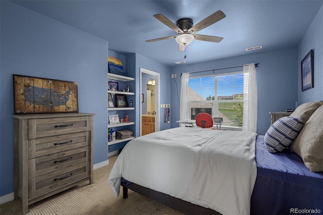 19735 Knights Xing, Monument, CO 80132 - bedroom with light carpet, connected bathroom, and ceiling fan