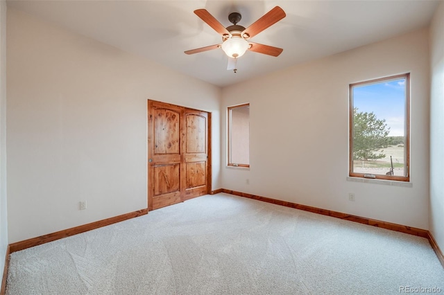 unfurnished bedroom with carpet floors, baseboards, and ceiling fan