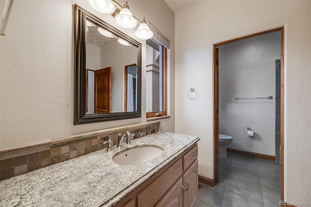 bathroom with vanity, tasteful backsplash, toilet, and tile patterned flooring