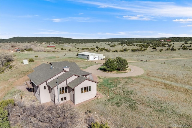 birds eye view of property with a rural view