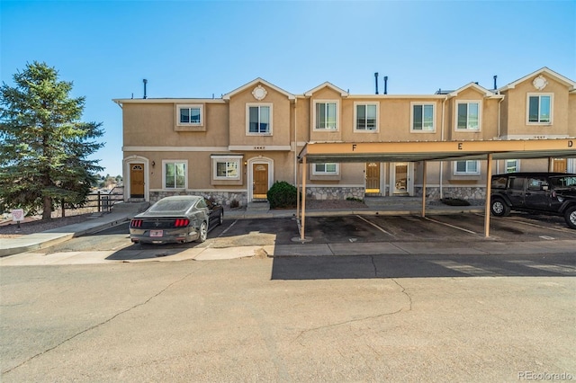 1447 Madison Ridge Hts, Colorado Springs, CO 80904 - multi unit property featuring covered parking, stucco siding, and stone siding