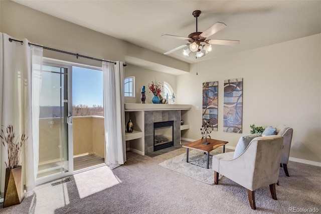 1447 Madison Ridge Hts, Colorado Springs, CO 80904 - carpeted living room with ceiling fan, a tiled fireplace, and baseboards