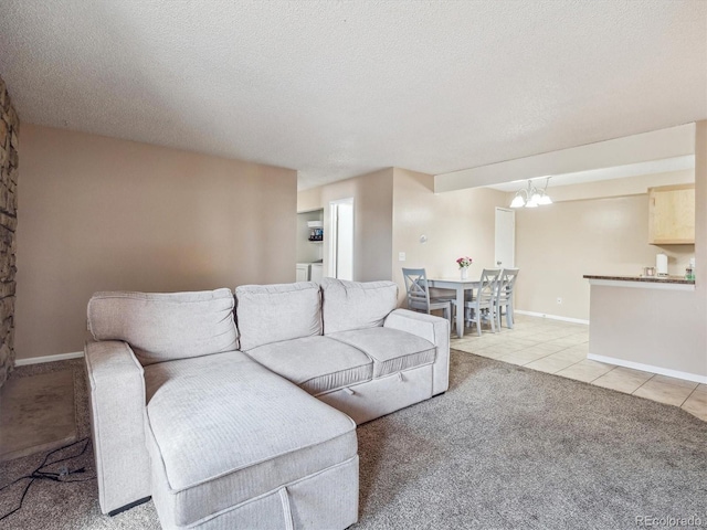 381 S Ames St Unit G101, Lakewood, CO 80226 - living area featuring light carpet, a chandelier, light tile patterned flooring, and a textured ceiling