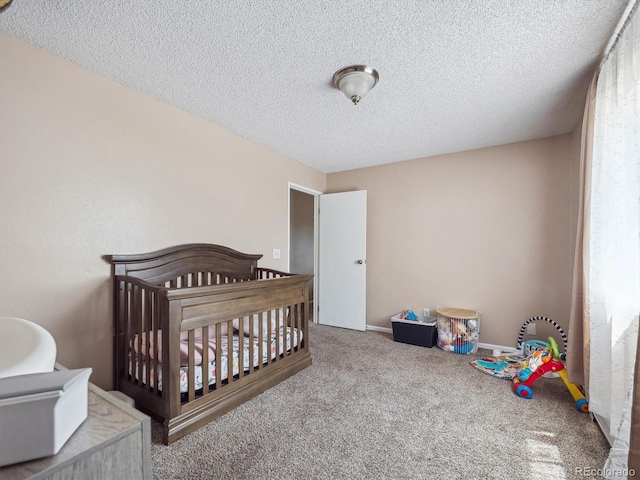 381 S Ames St Unit G101, Lakewood, CO 80226 - bedroom featuring a textured ceiling, a nursery area, and carpet floors