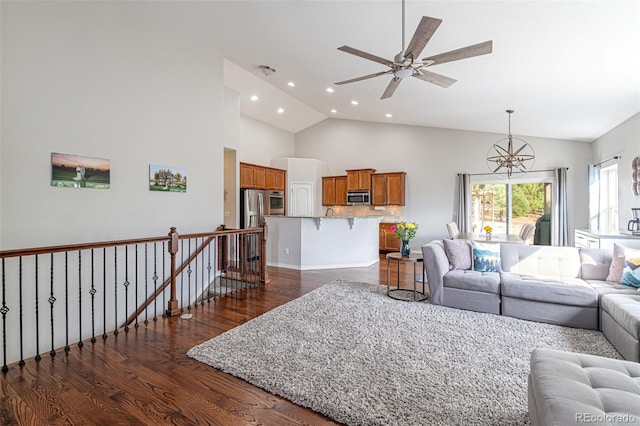 living room with high vaulted ceiling, ceiling fan, and dark hardwood / wood-style floors