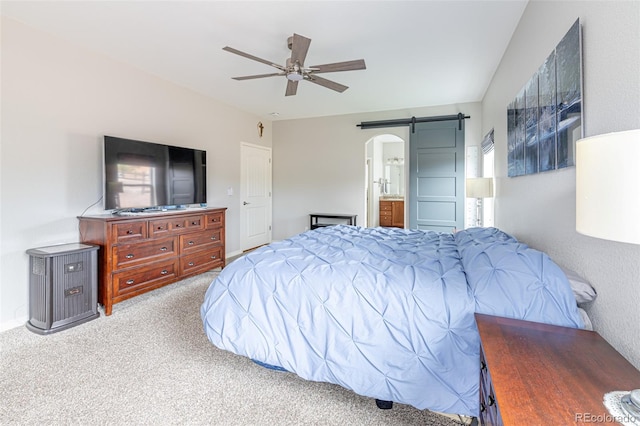 carpeted bedroom with ceiling fan and connected bathroom