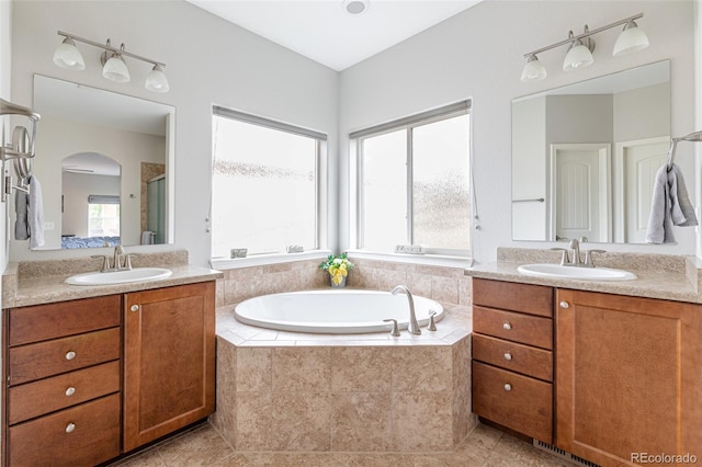 bathroom with vanity, tile patterned flooring, and a healthy amount of sunlight